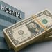 Modern hospital exterior symbolizing healthcare funding challenges and limited government support