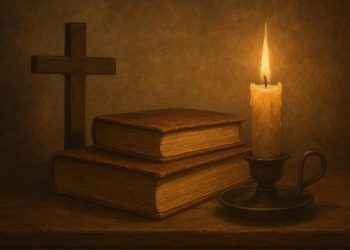 Open Bible on wooden table with cross symbolizing Christian debate on free will and predestination