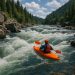Whitewater river with visible rapids and rocks illustrating kayaking difficulty levels