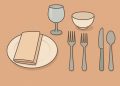 Elegant table setting displaying proper mealtime etiquette with neatly arranged dishes and utensils.